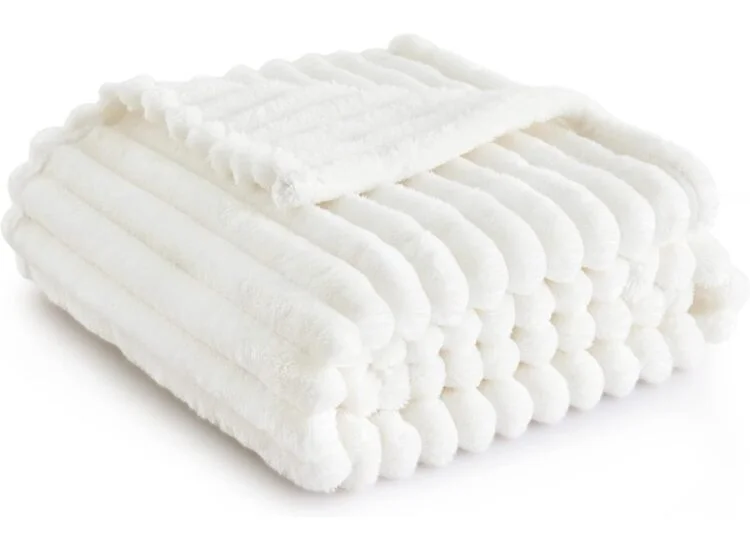 Folded white plush faux fur throw blanket by Beckham Hotel Collection, soft and cozy texture.
